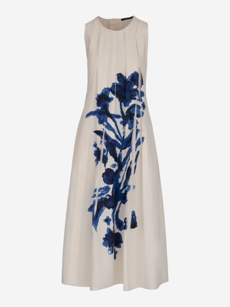A sleeveless knee-length dress with a solid white color and blue floral print.