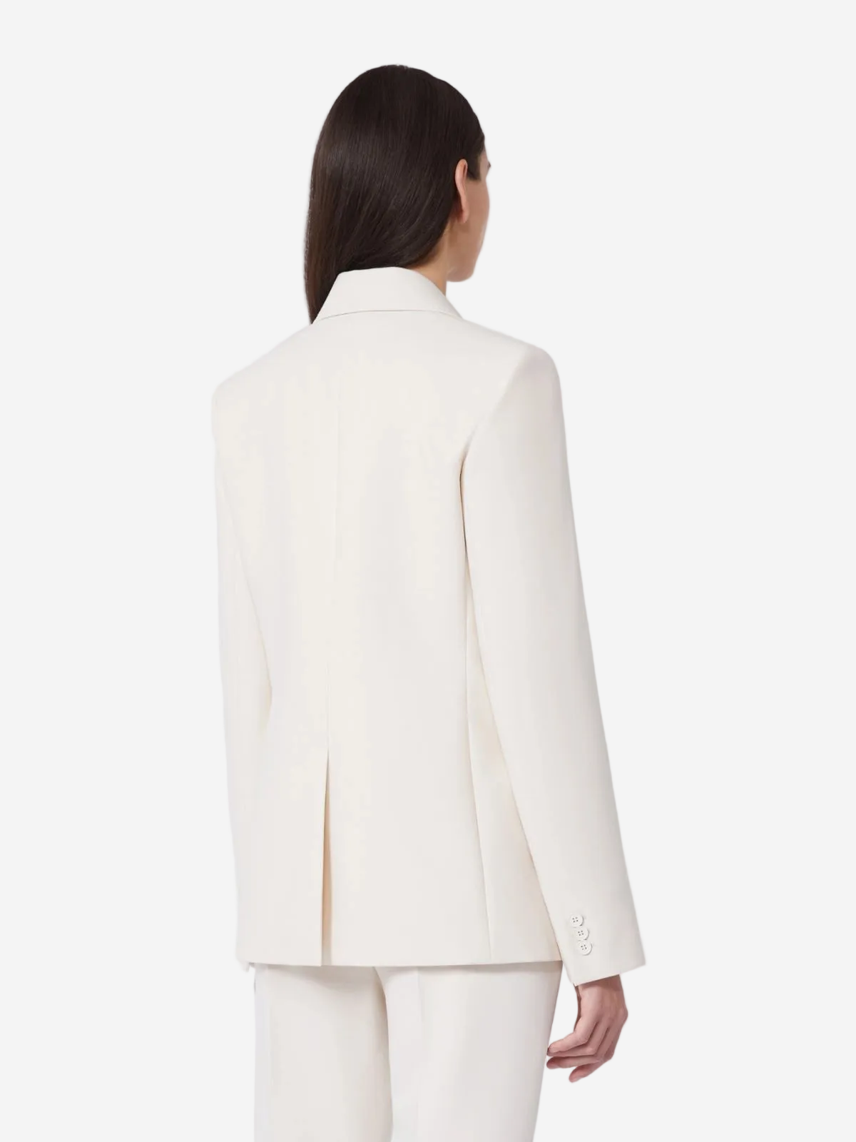 Person wearing a white suit on a plain background