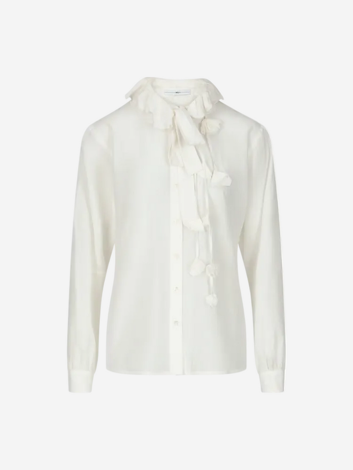 A white cotton and silk poplin shirt with round neckline, button-thru front, and decorative elements on the neckline and cuffs.