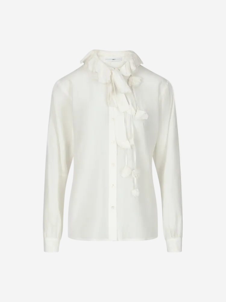 A white cotton and silk poplin shirt with round neckline, button-thru front, and decorative elements on the neckline and cuffs.