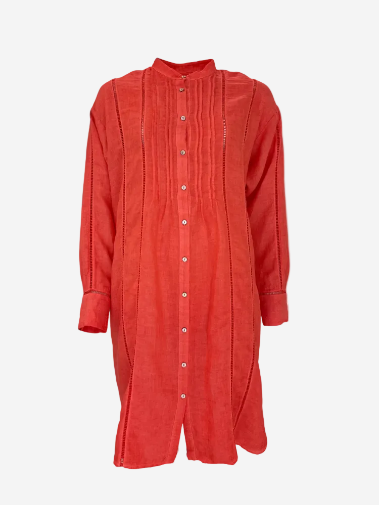 A above-knee length coral red short dress with ladder lace pintuck detailing and button-down front.