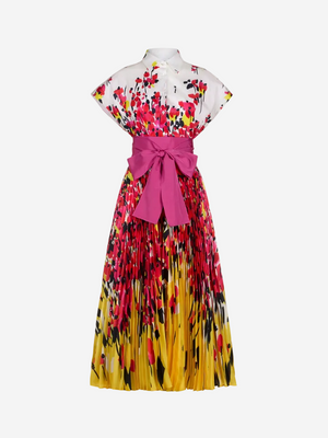 A pleated long dress with a floral pattern in shades of pink and yellow, featuring a pink belt at the waist.