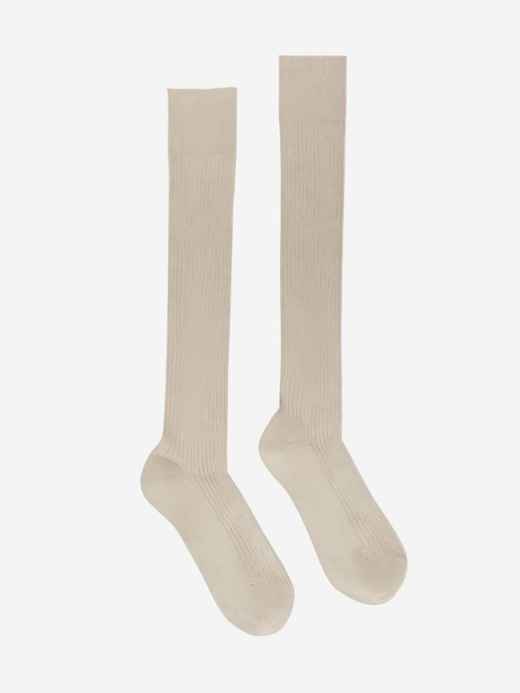 Pair of beige knee-high socks on a white background