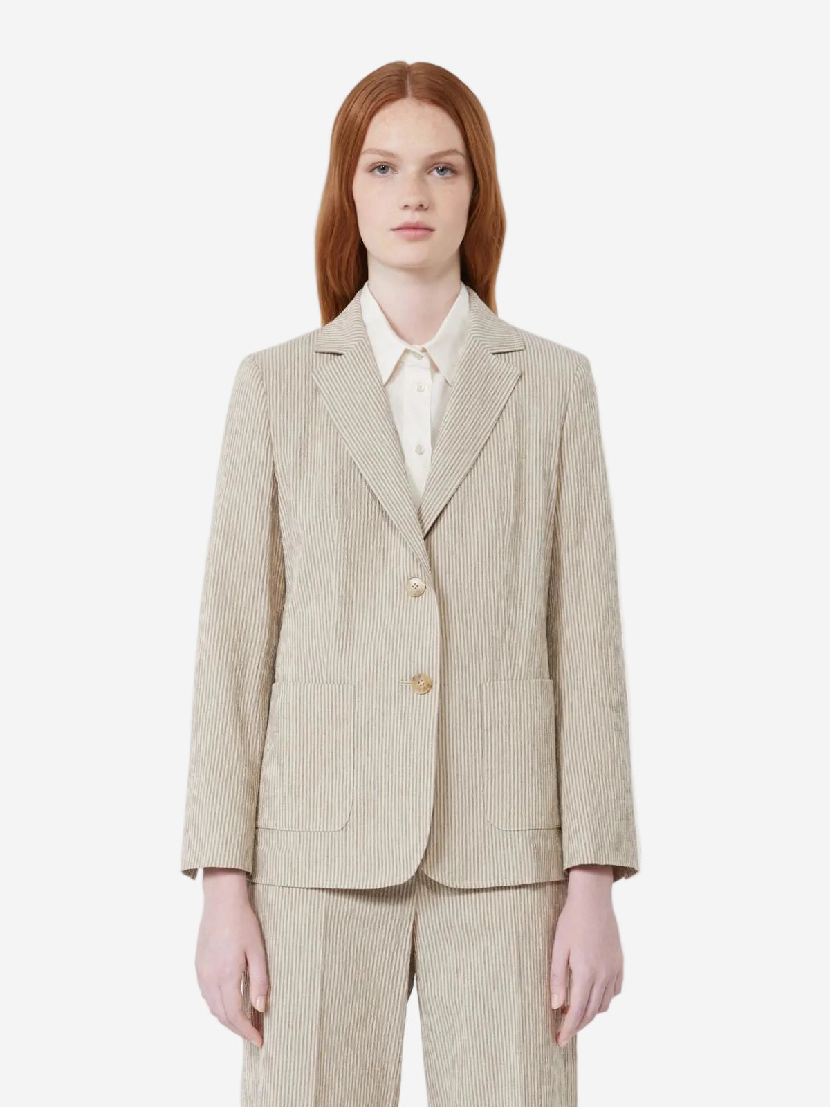 Woman wearing a beige pinstripe suit on a white background