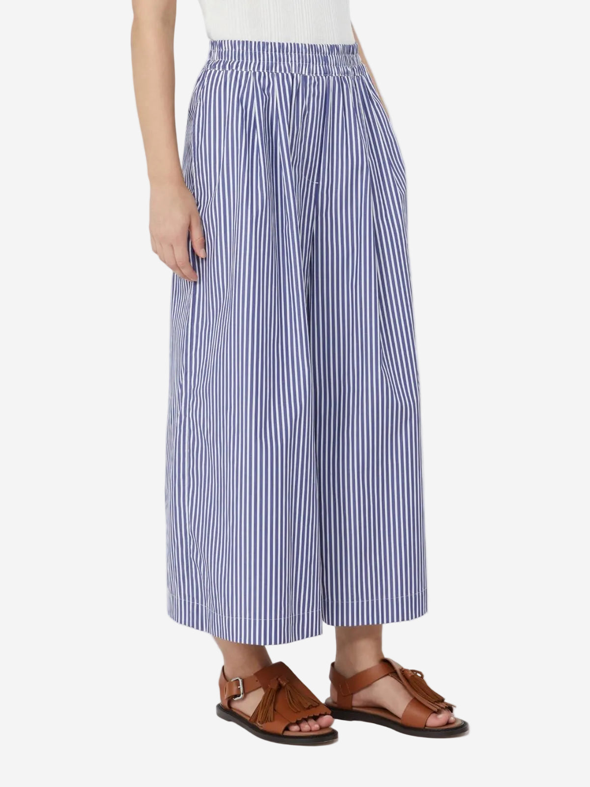 Person wearing blue and white striped wide-leg pants on a white background