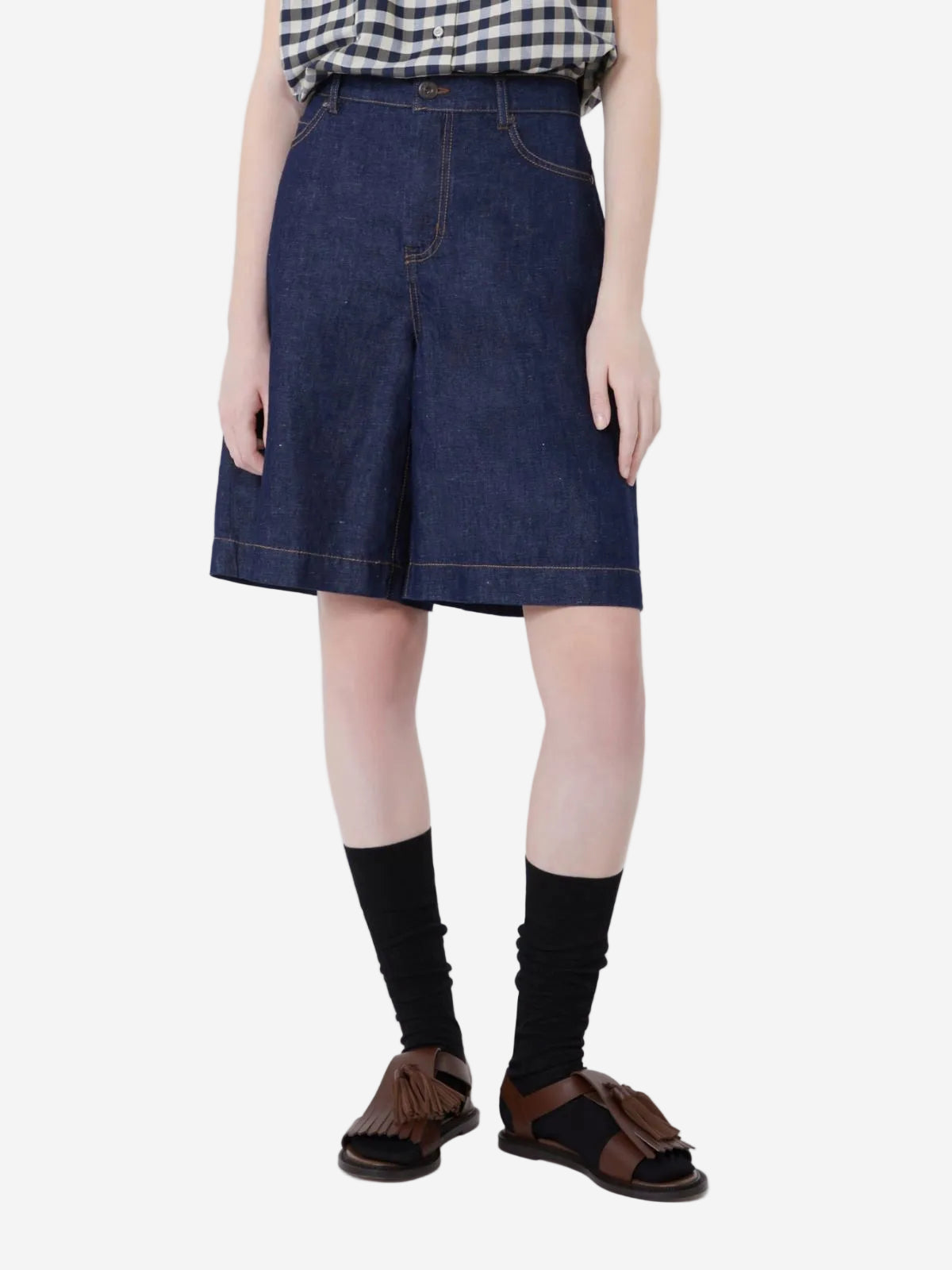 Person wearing a dark denim skirt on a white background, stocked at Christensen Copenhagen.