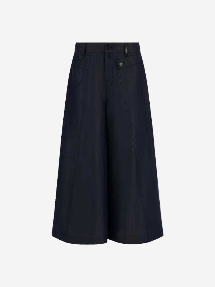 A pair of navy blue wide-leg pants with a high waist and button fly closure.