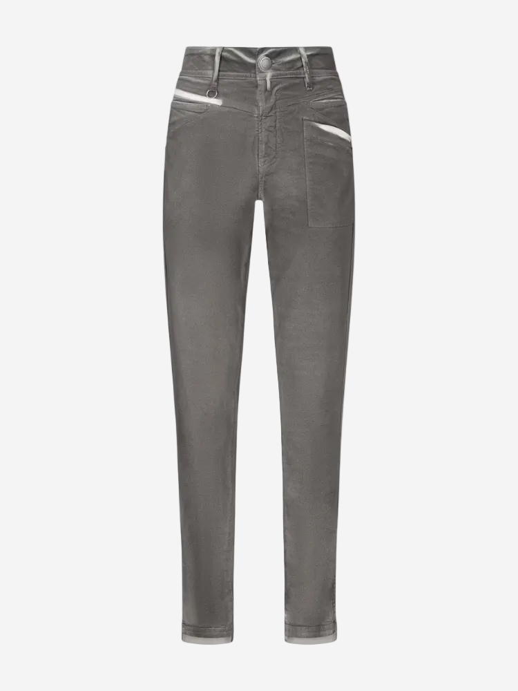 A pair of grey slim-fit jeans with a fixed waistband, belt loops, and a silver metal zip. The jeans have a heritage style with a short fly front, v-shaped hip yoke, and hip pockets.