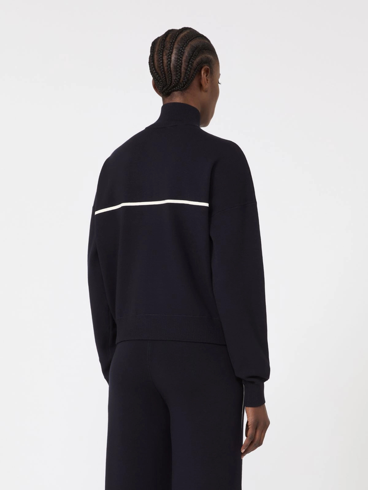 Person wearing a black tracksuit with a white stripe on a white background