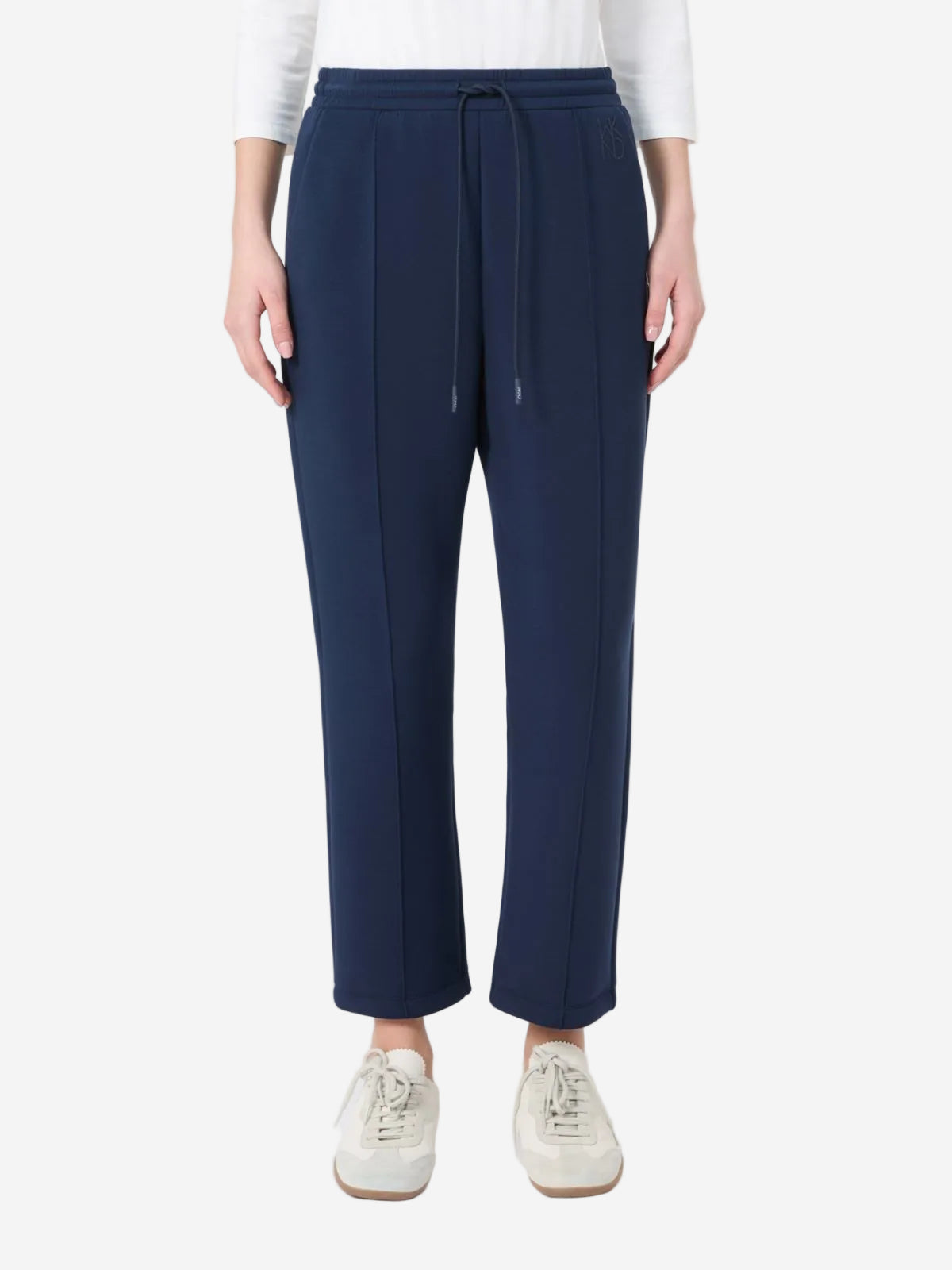 Navy blue pants worn by a person on a white background