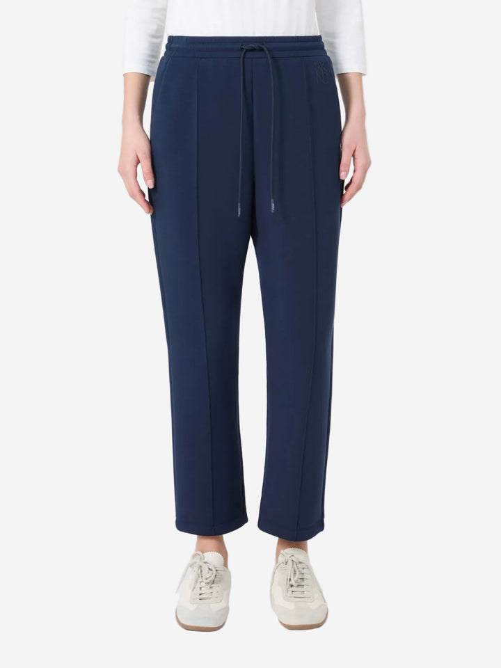 Navy blue pants worn by a person on a white background