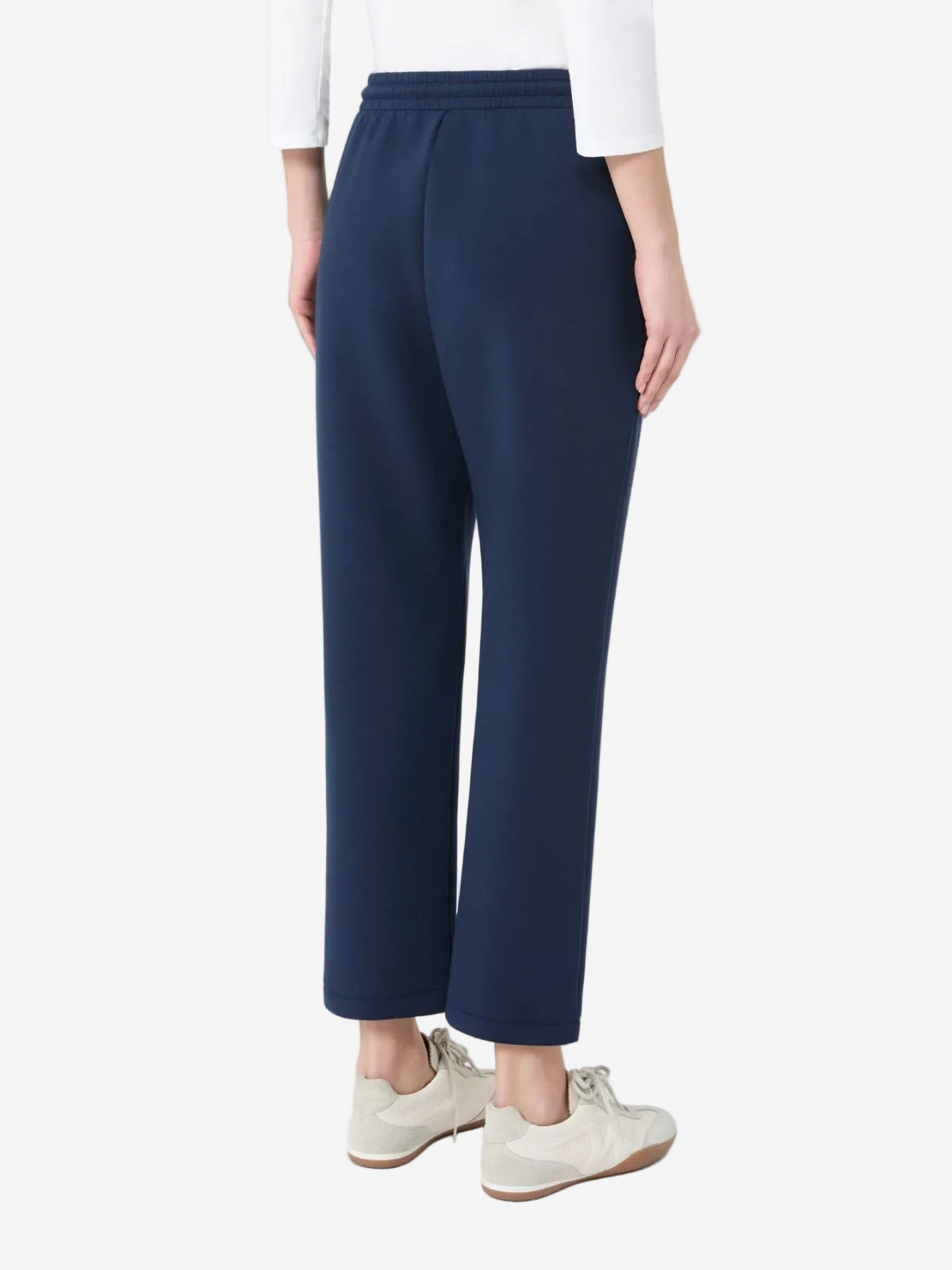 Navy blue pants worn by a person on a white background