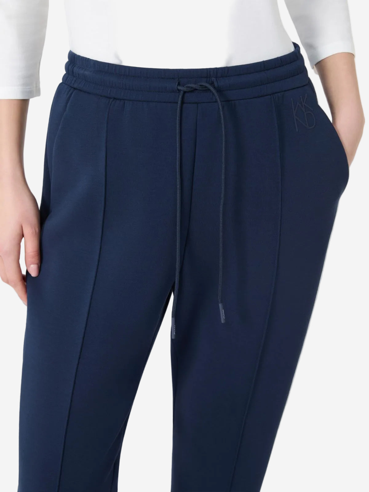 Navy blue pants with a drawstring on a white background