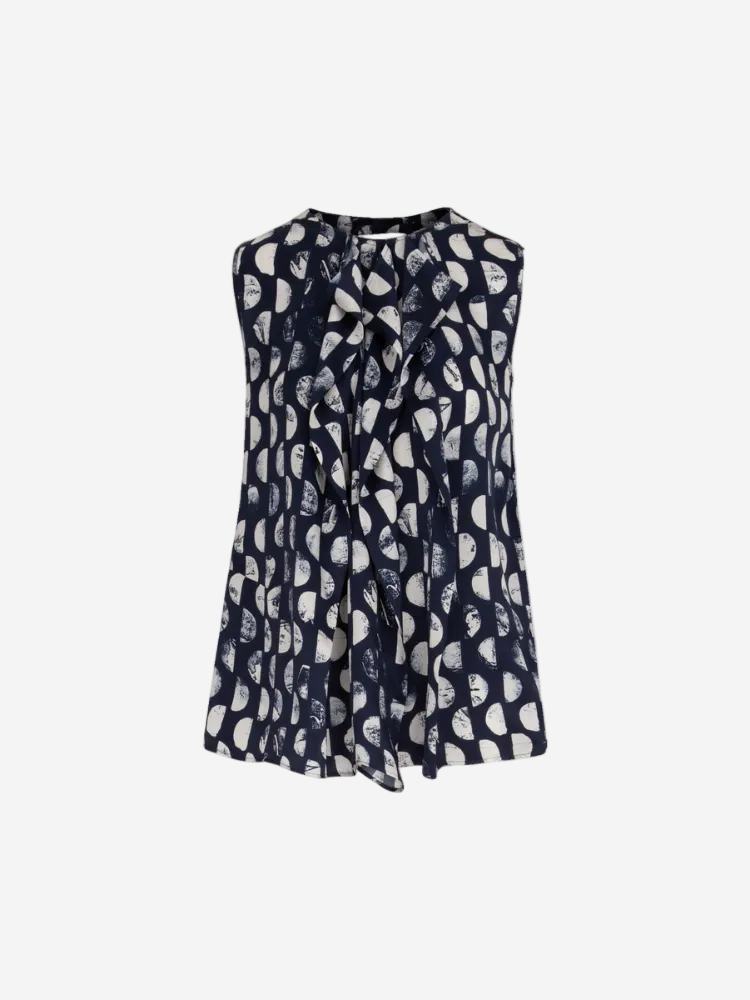 A sleeveless navy top with a geometric pattern and a tie detail at the neckline.