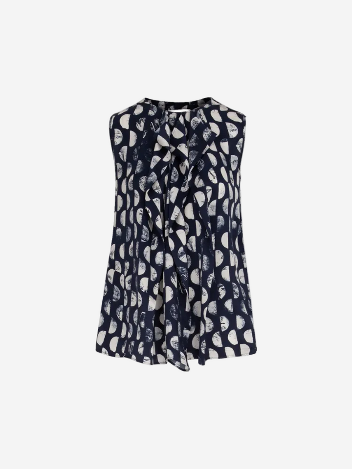 A sleeveless navy top with a geometric pattern and a tie detail at the neckline.
