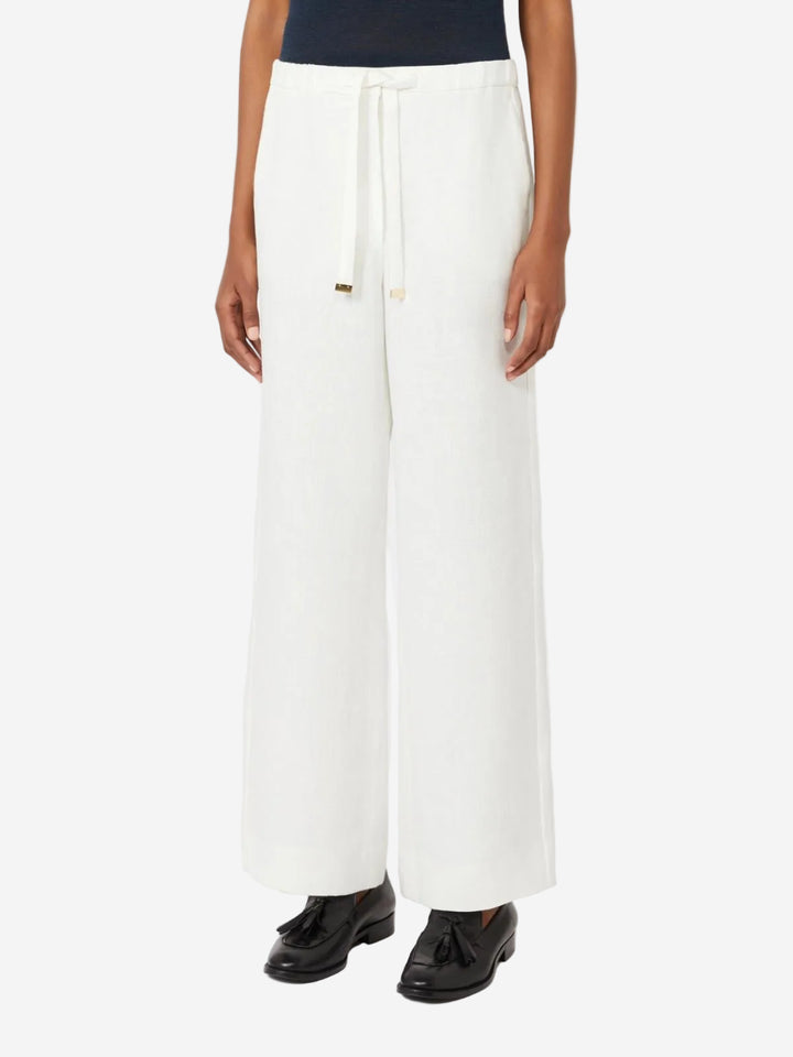 White pants worn by a person on a white background