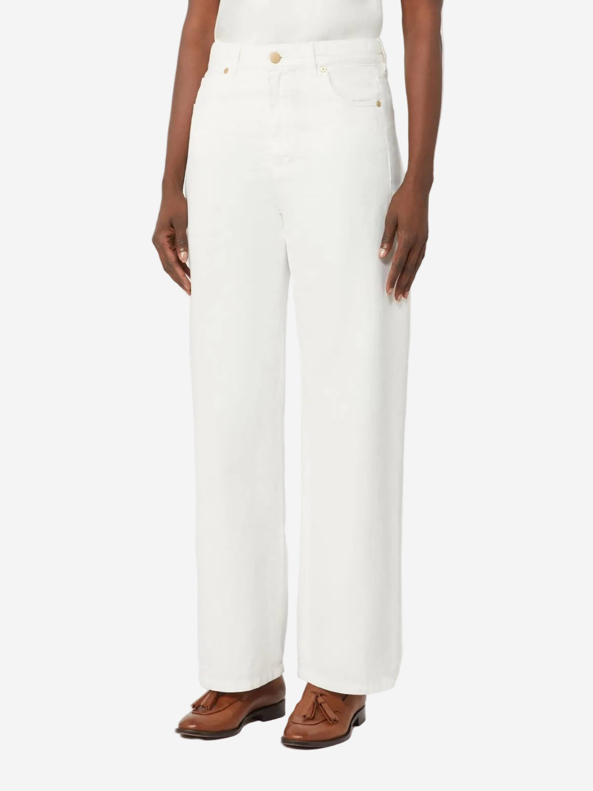 Person wearing white pants with brown shoes on a white background
