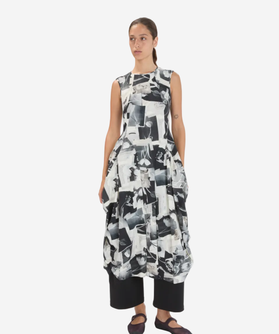 Woman wearing a black and white patterned dress on a white background