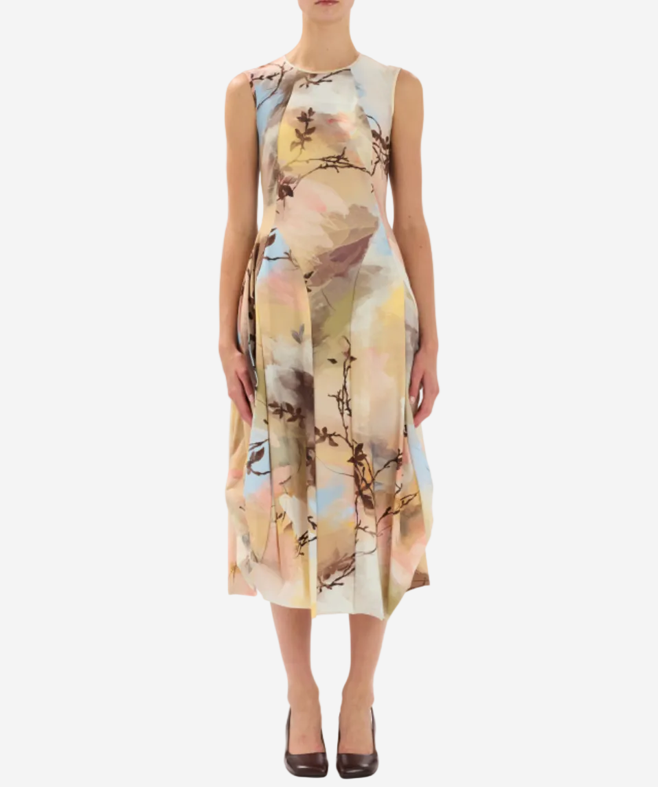 Woman wearing a sleeveless floral dress on a white background