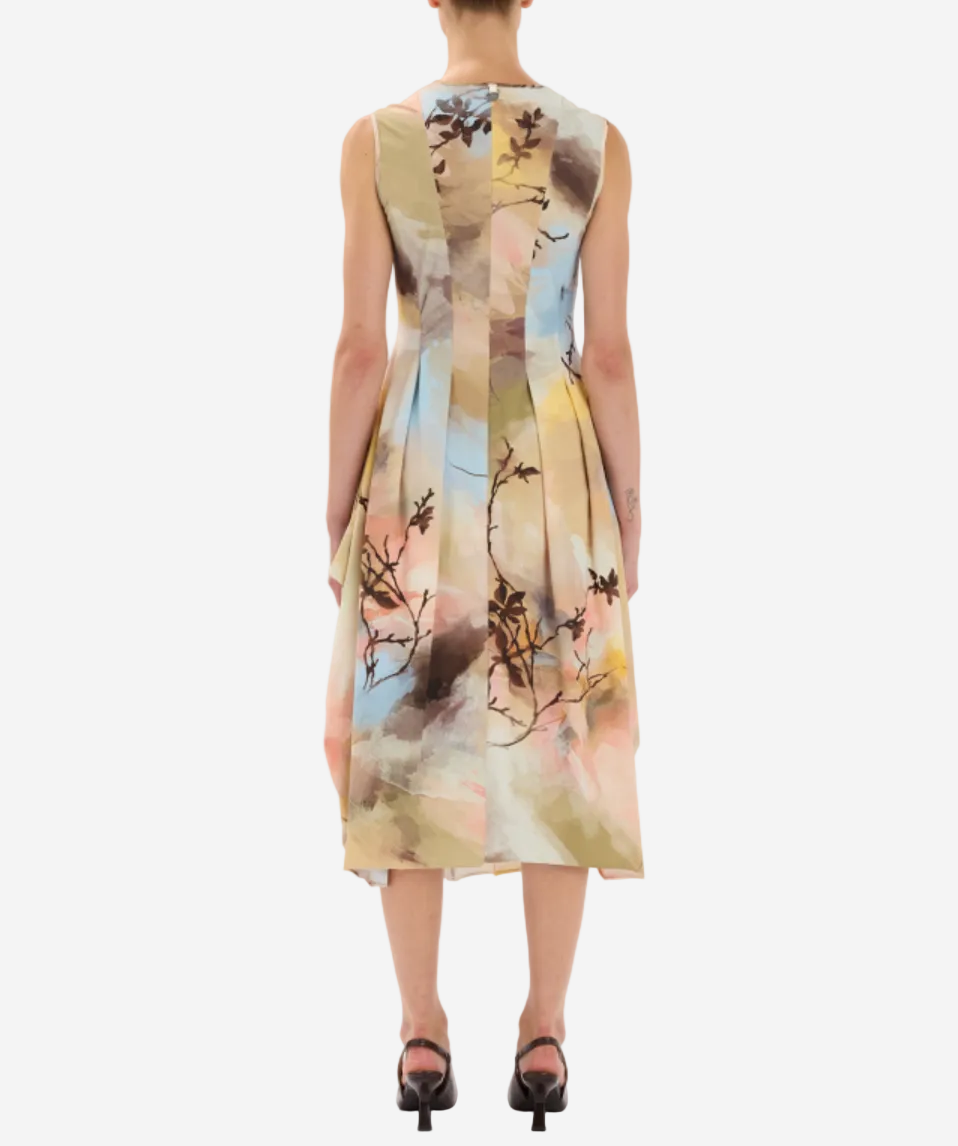 Woman wearing a sleeveless dress with floral pattern on a white background