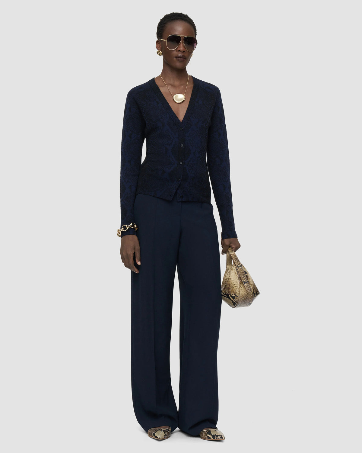 Model wearing the JOSEPH Aisha snake jacquard cardigan with the JOSEPH Mitae wide-leg trousers in Prussian blue