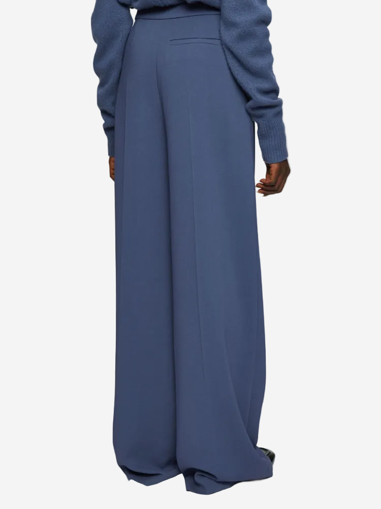 Blue wide-leg pants worn by a person on a white background