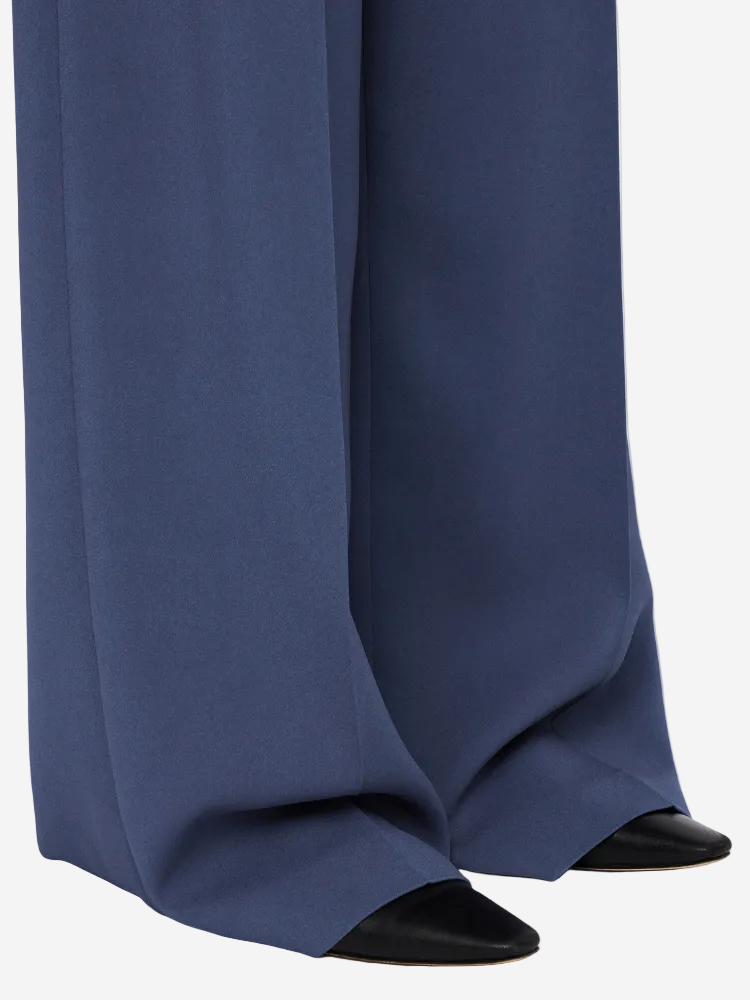 Navy blue pants with black shoes on a white background