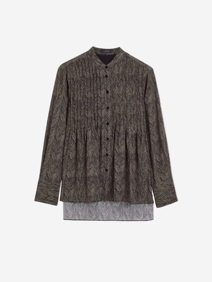 A long-sleeved Albin Blouse in a animal pattern with a collar, button-up front, and a longer hemline in the front.