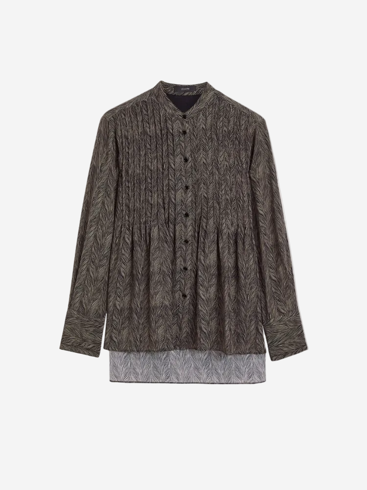 A long-sleeved Albin Blouse in a animal pattern with a collar, button-up front, and a longer hemline in the front.