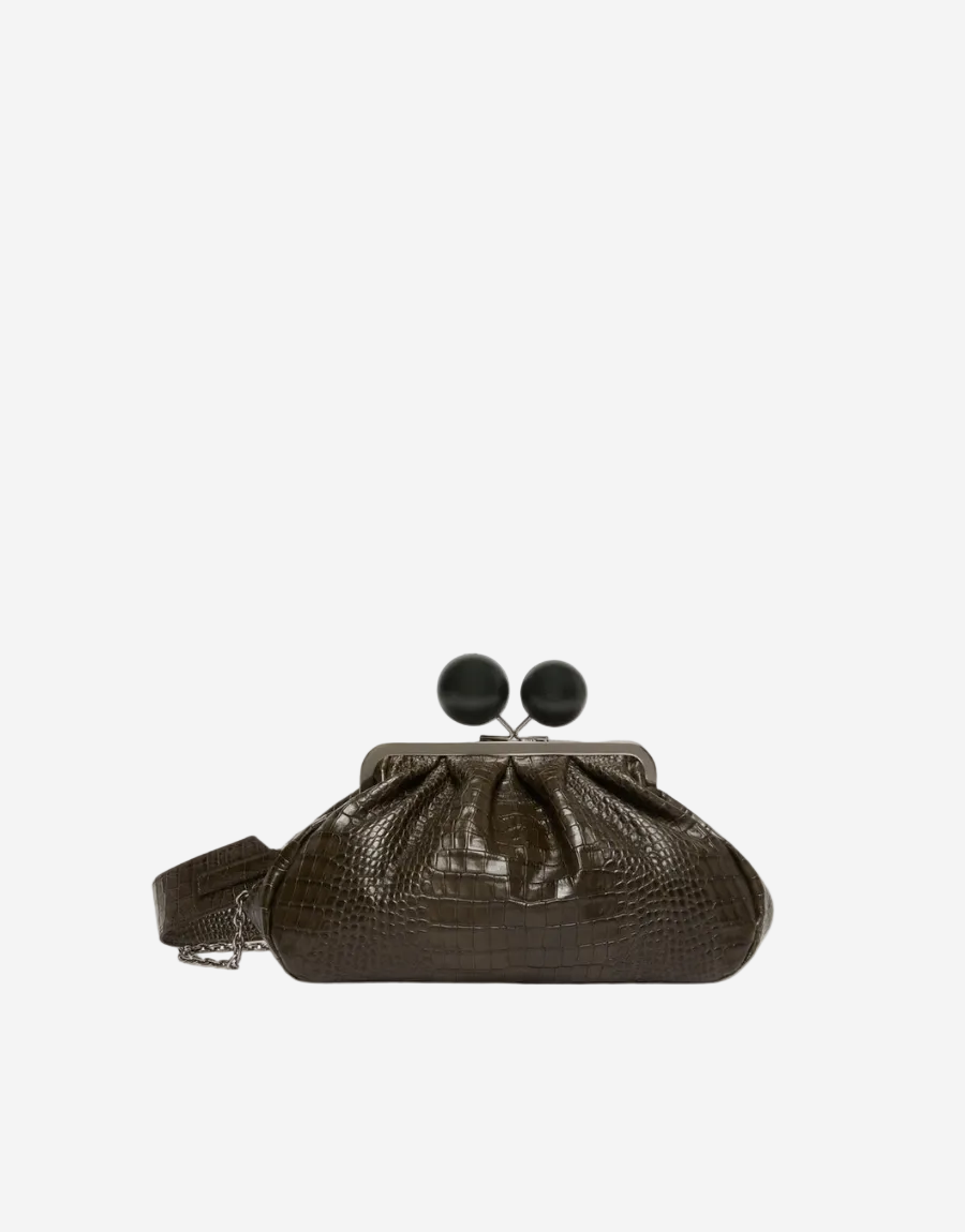 Brown crocodile skin handbag with black frame on a white background