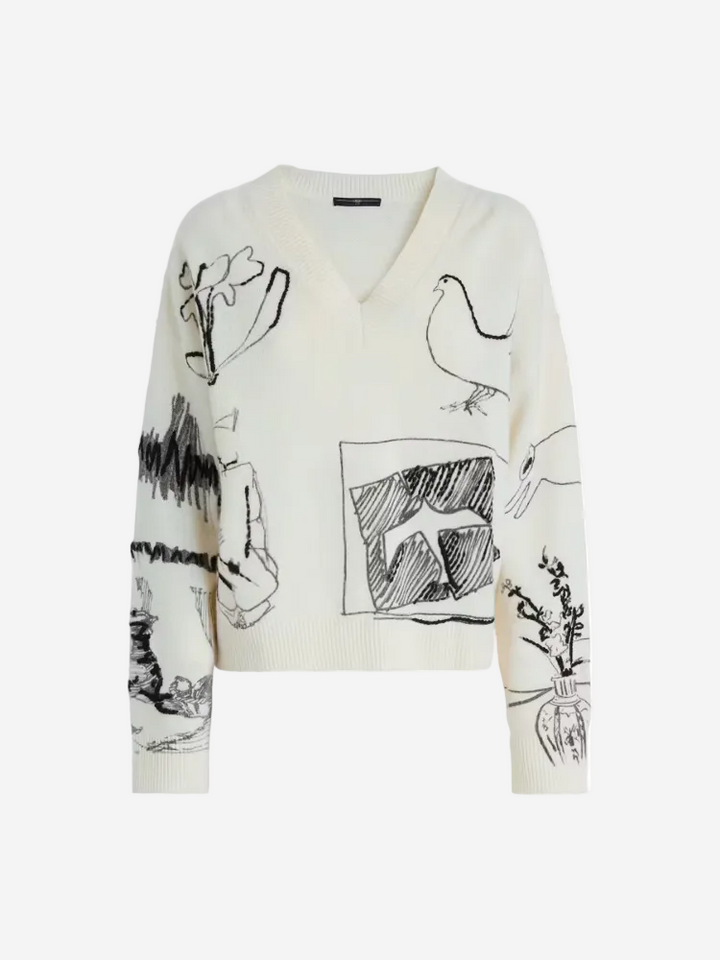 White sweater with black abstract designs on a white background