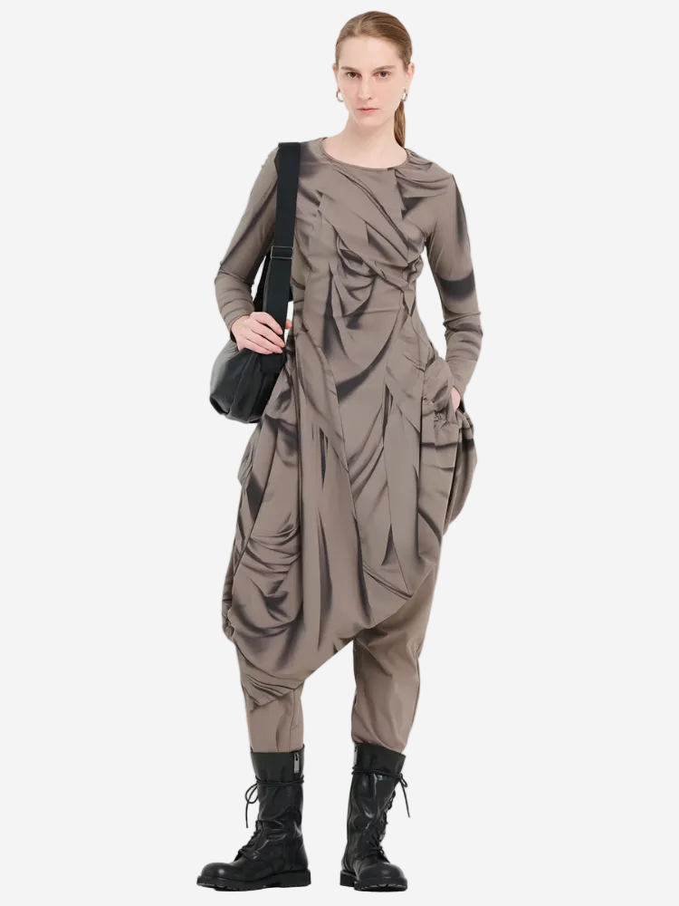 Woman wearing a brown outfit with ruched details and black boots on a white background