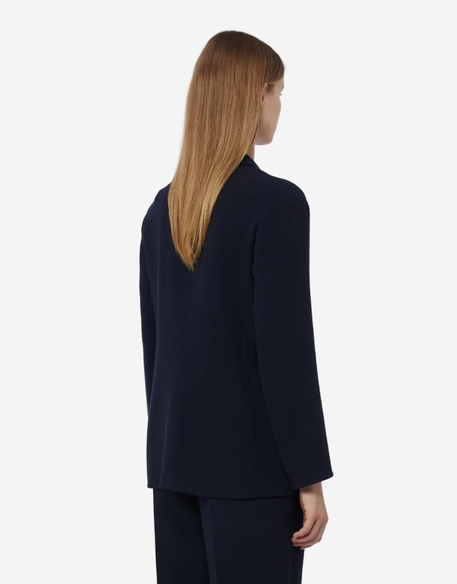 Person wearing a navy blue suit on a white background