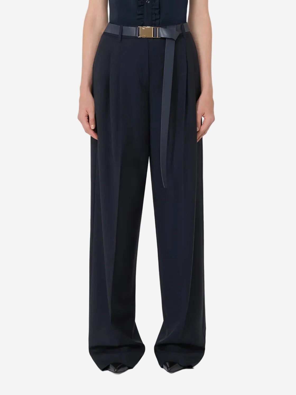 Person wearing black wide-leg pants with a belt on a white background