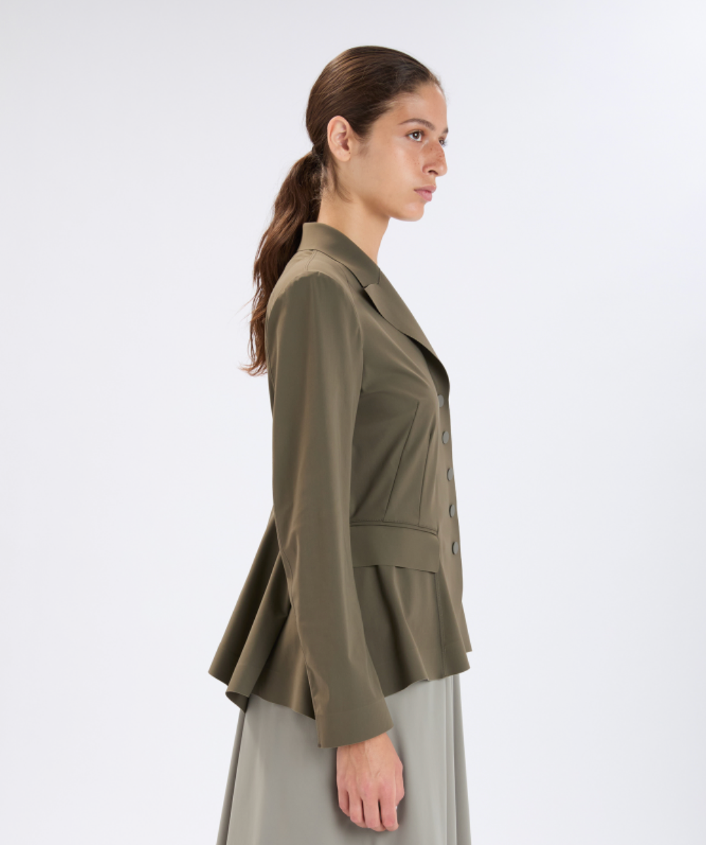 Woman wearing a green jacket on a white background