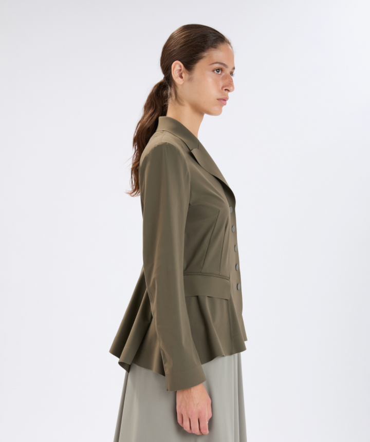 Woman wearing a green jacket on a white background