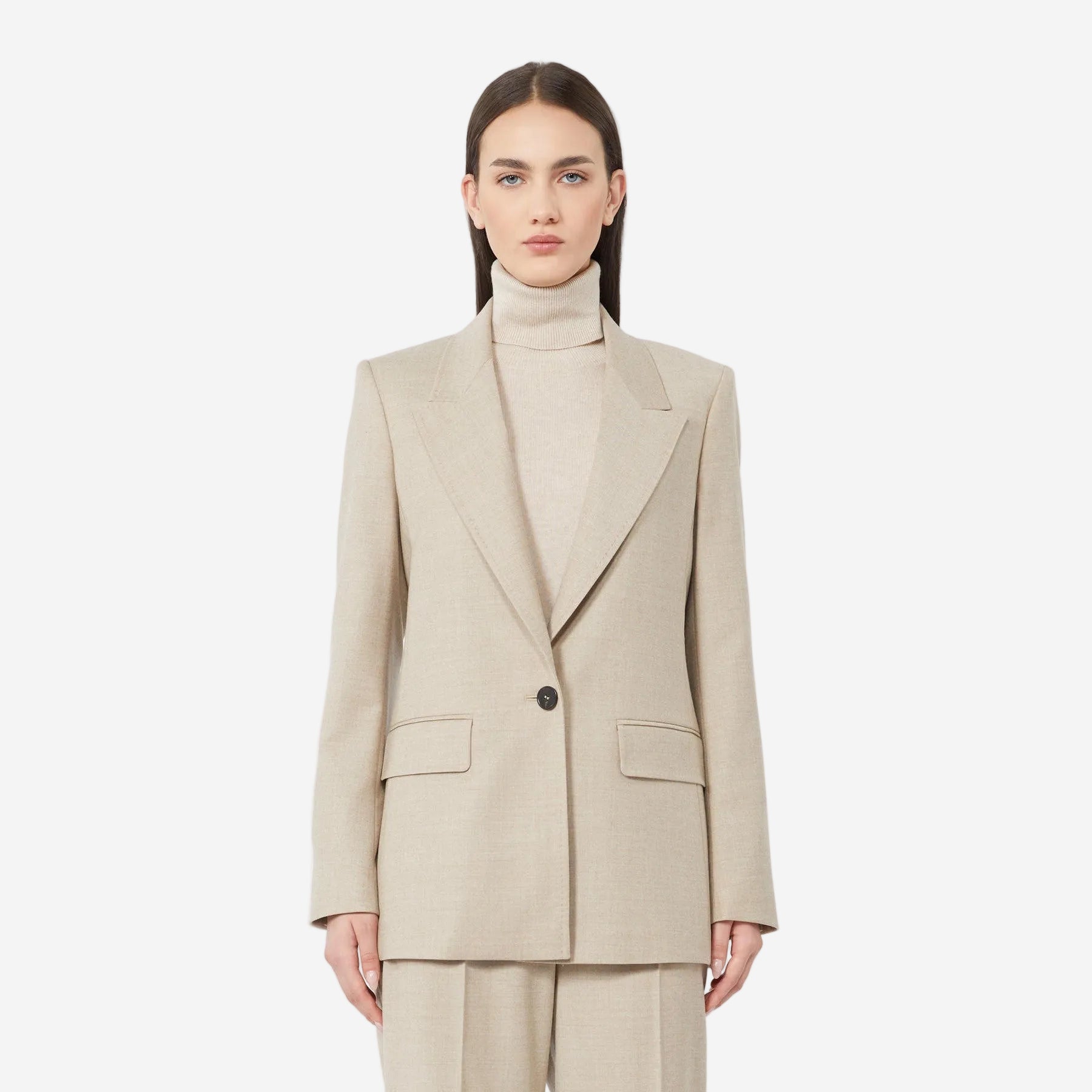 Woman wearing a beige suit on a white background