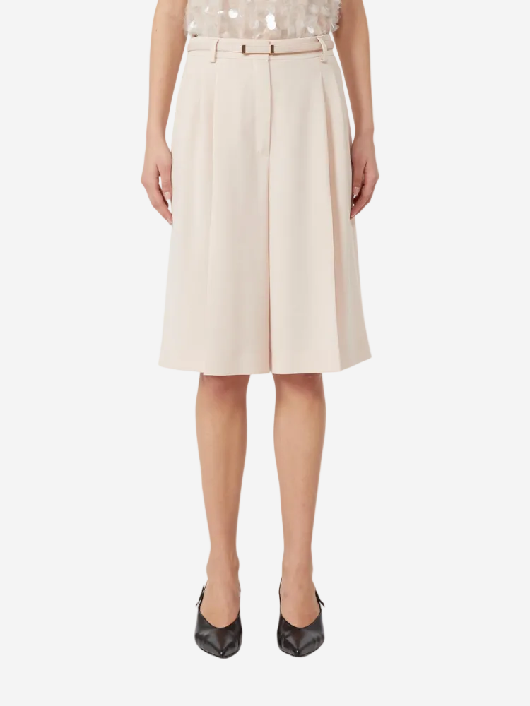 Beige skirt worn by a person on a white background