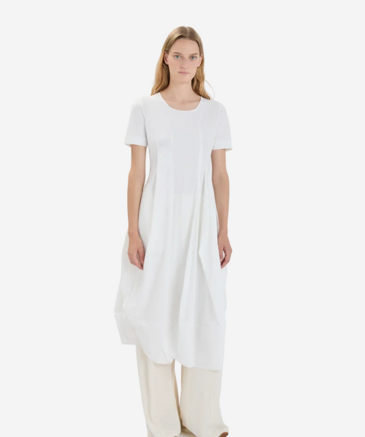 Woman wearing a white dress on a plain background