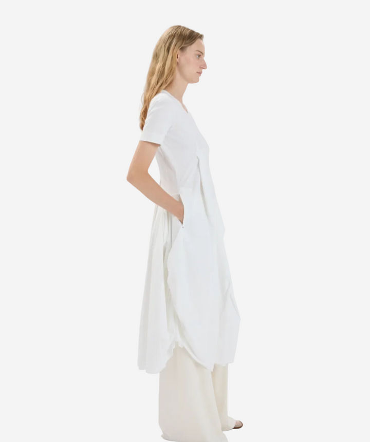 Woman wearing a white dress with a plain background