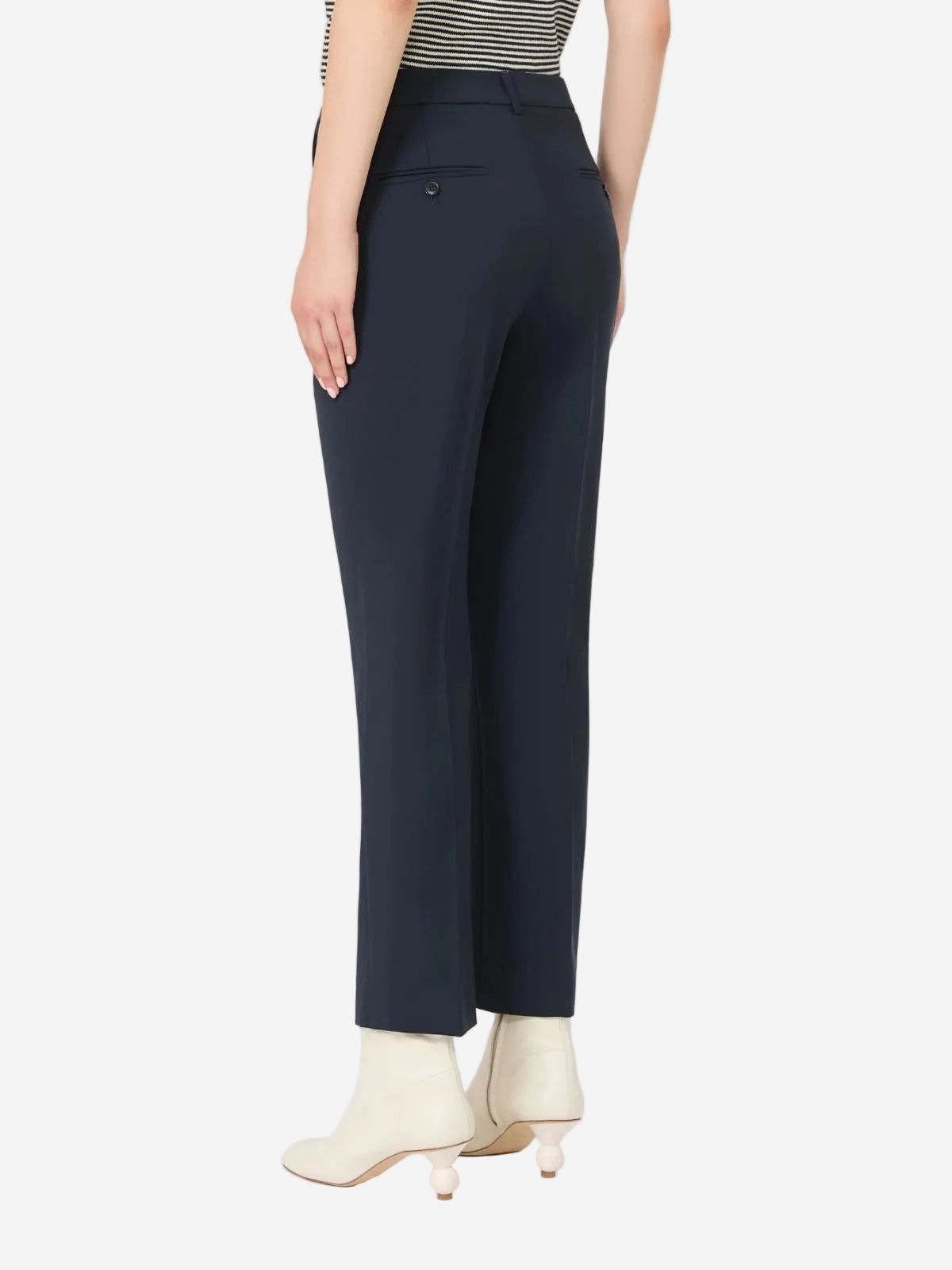 Navy pants worn by a person on a white background