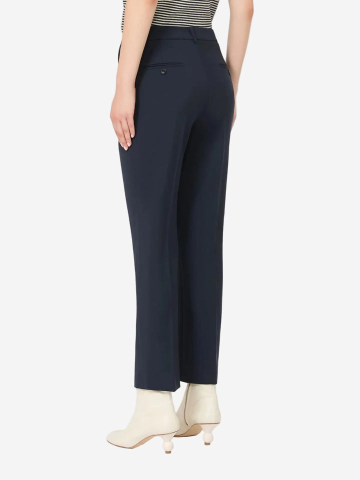 Navy pants worn by a person on a white background
