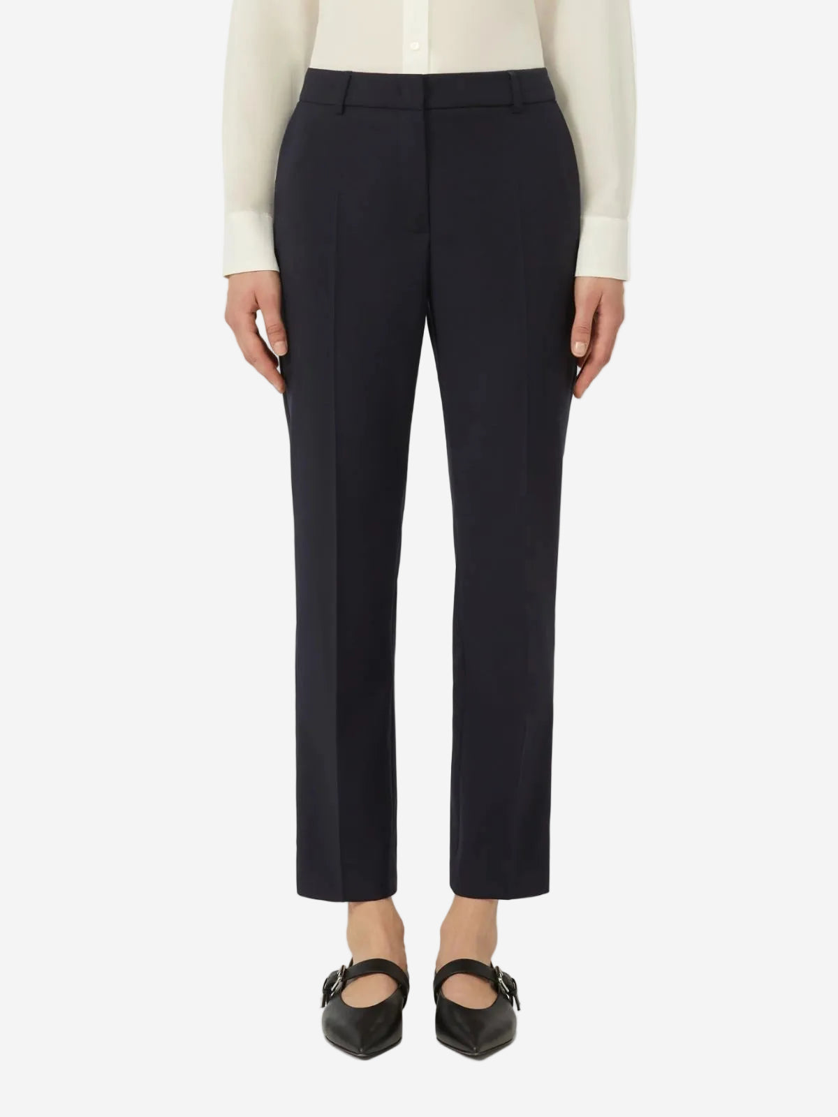 Black pants worn by a person on a white background
