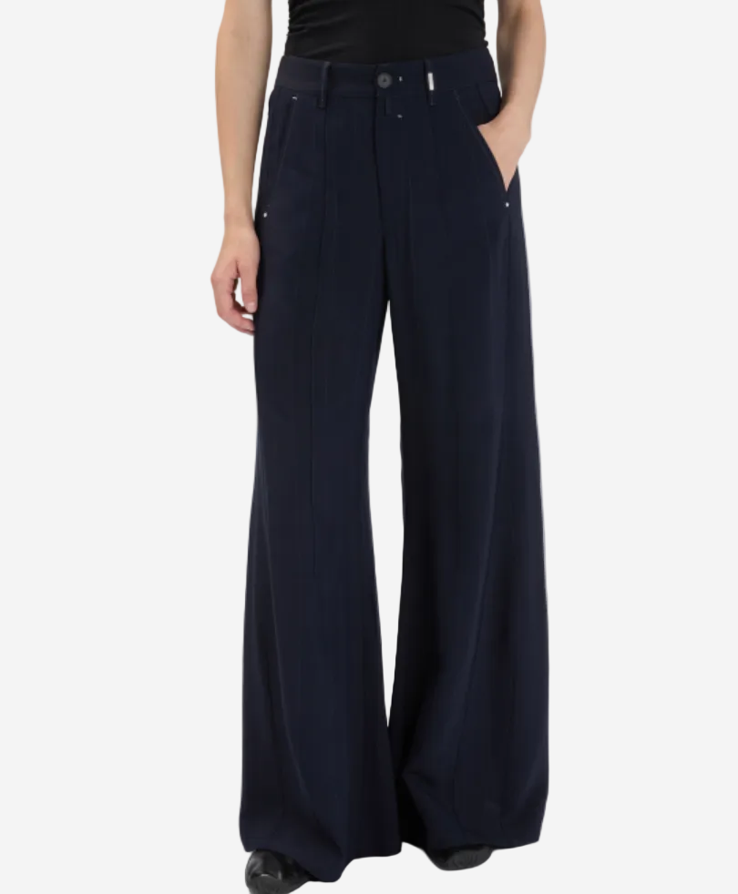 Person wearing navy wide-leg pants on a white background
