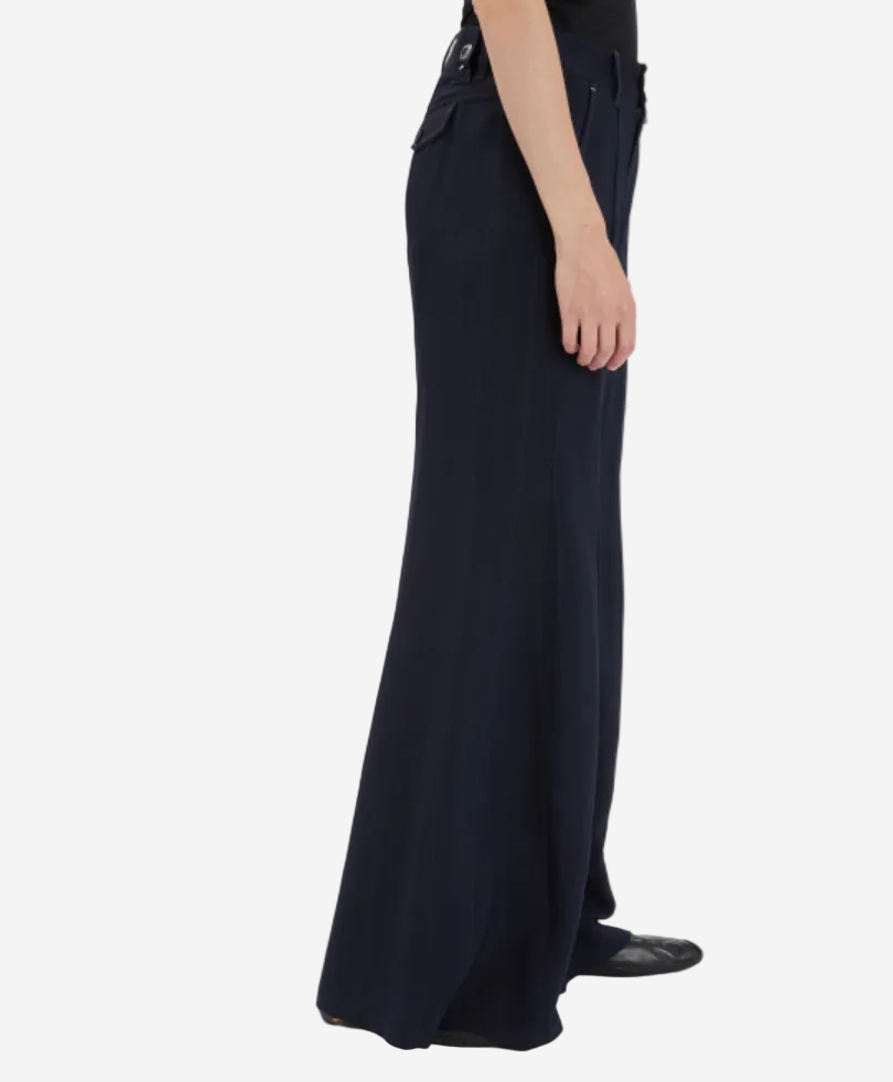 Navy blue wide-leg pants worn by a person on a white background