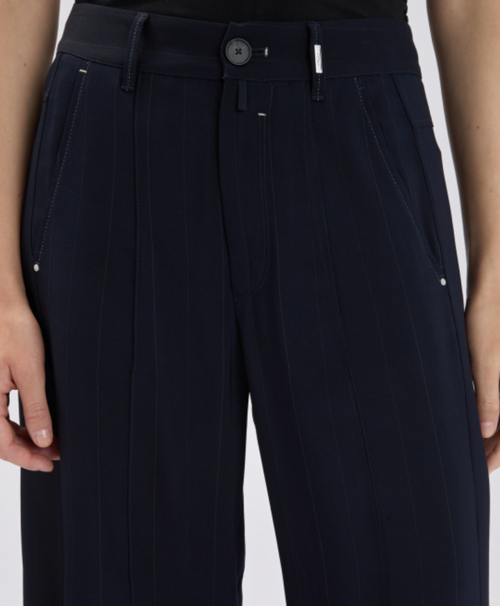 Black pants with a button detail on a white background