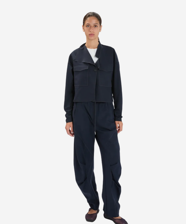 Person wearing a dark navy outfit on a white background