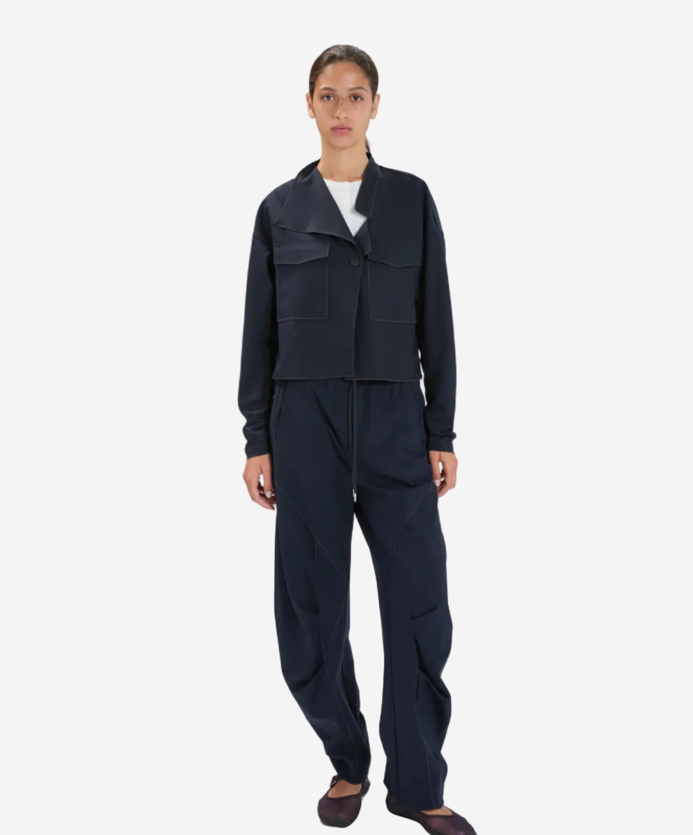 Person wearing a dark navy outfit on a white background