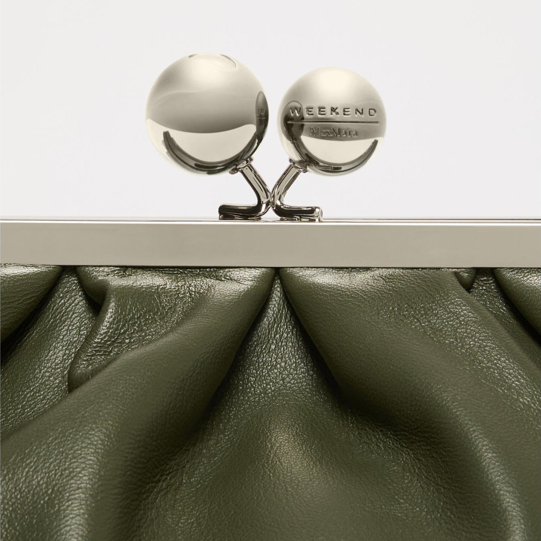 Silver clutch with 'Weekend' text on a white background