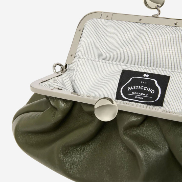 Green clutch bag with a visible brand label on a white background